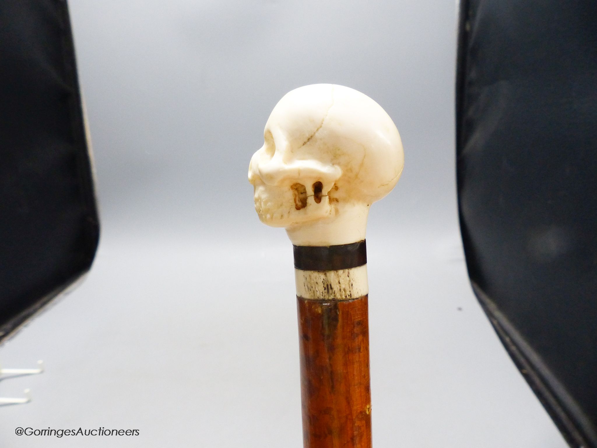 A malacca and ivory skull handled walking stick